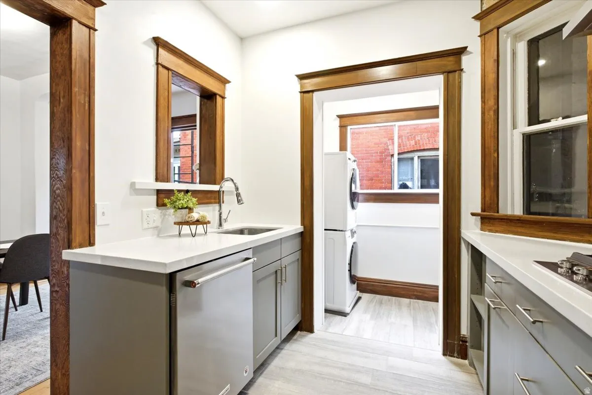 Utility space featuring light wood-finish flooring, white countertops, and gray cabinetry