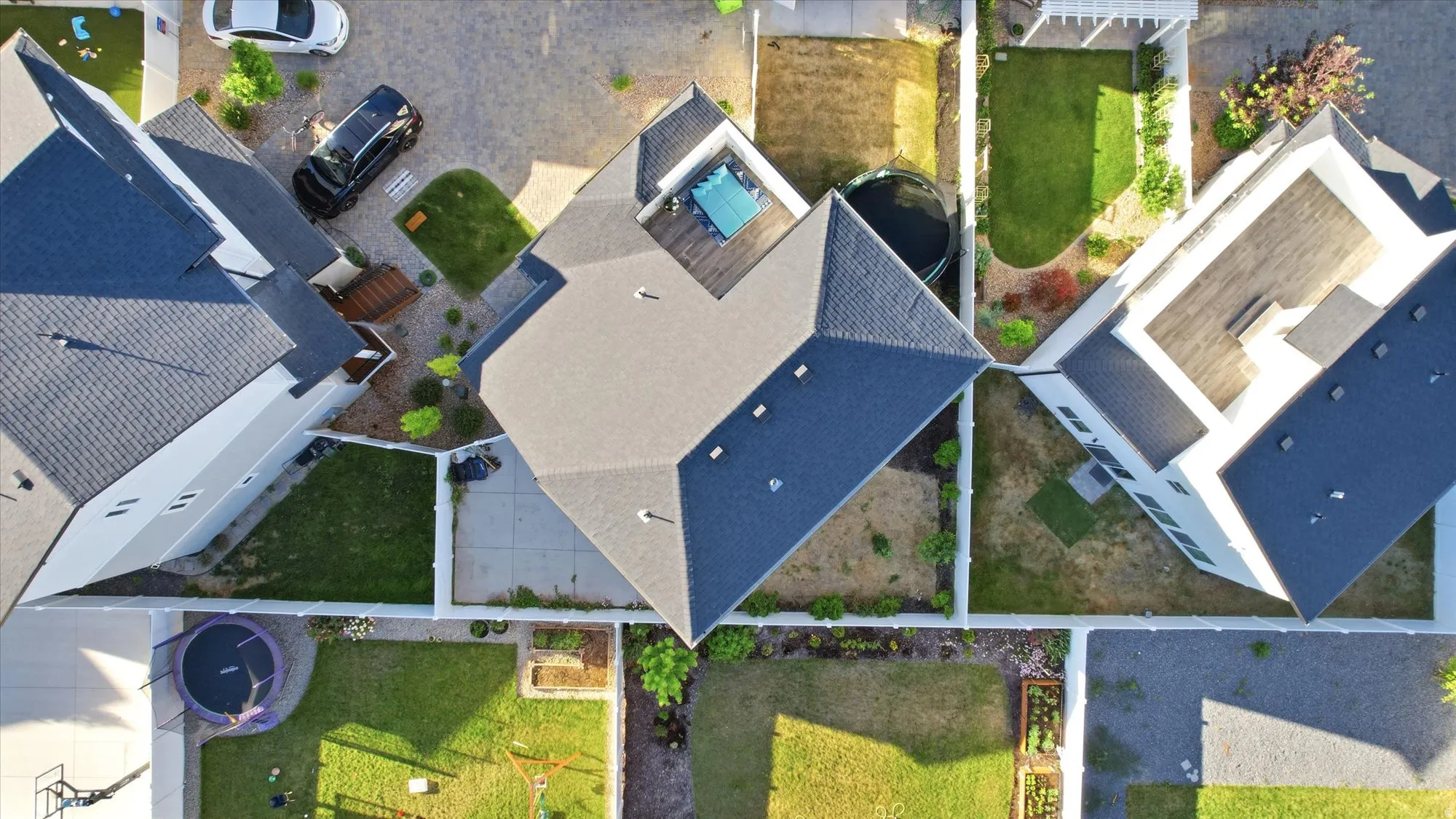 Contemporary residence featuring a multi-pitched roofline and a private backyard with a wooden deck and integrated pool