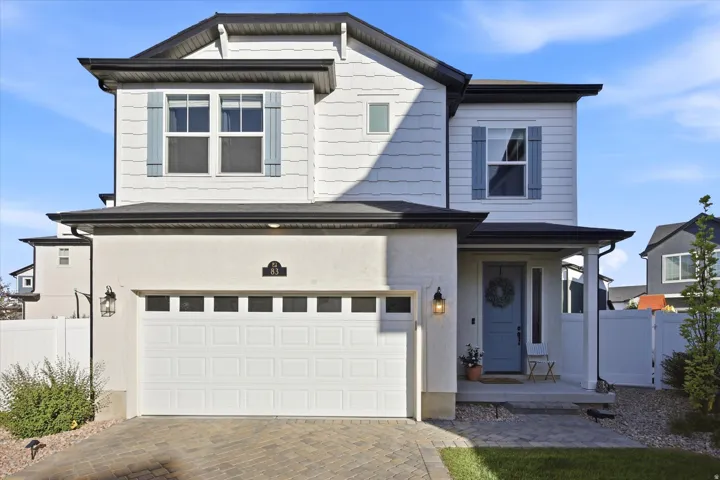 Contemporary two-story exterior featuring a light blue front door and matching shutters