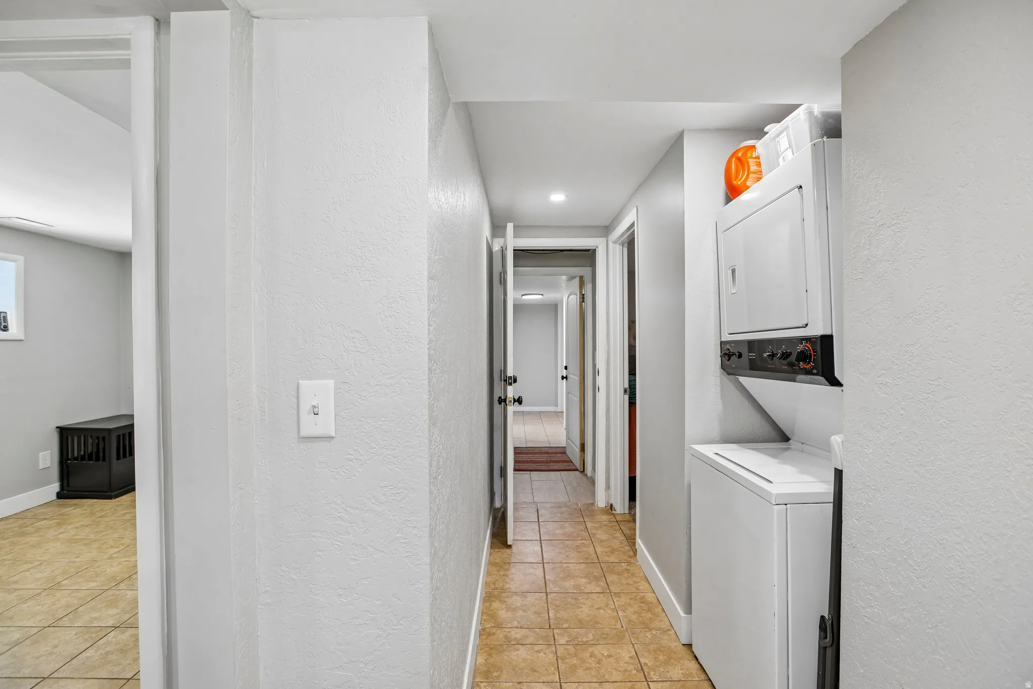 Hallway featuring neutral wall colors and tile flooring