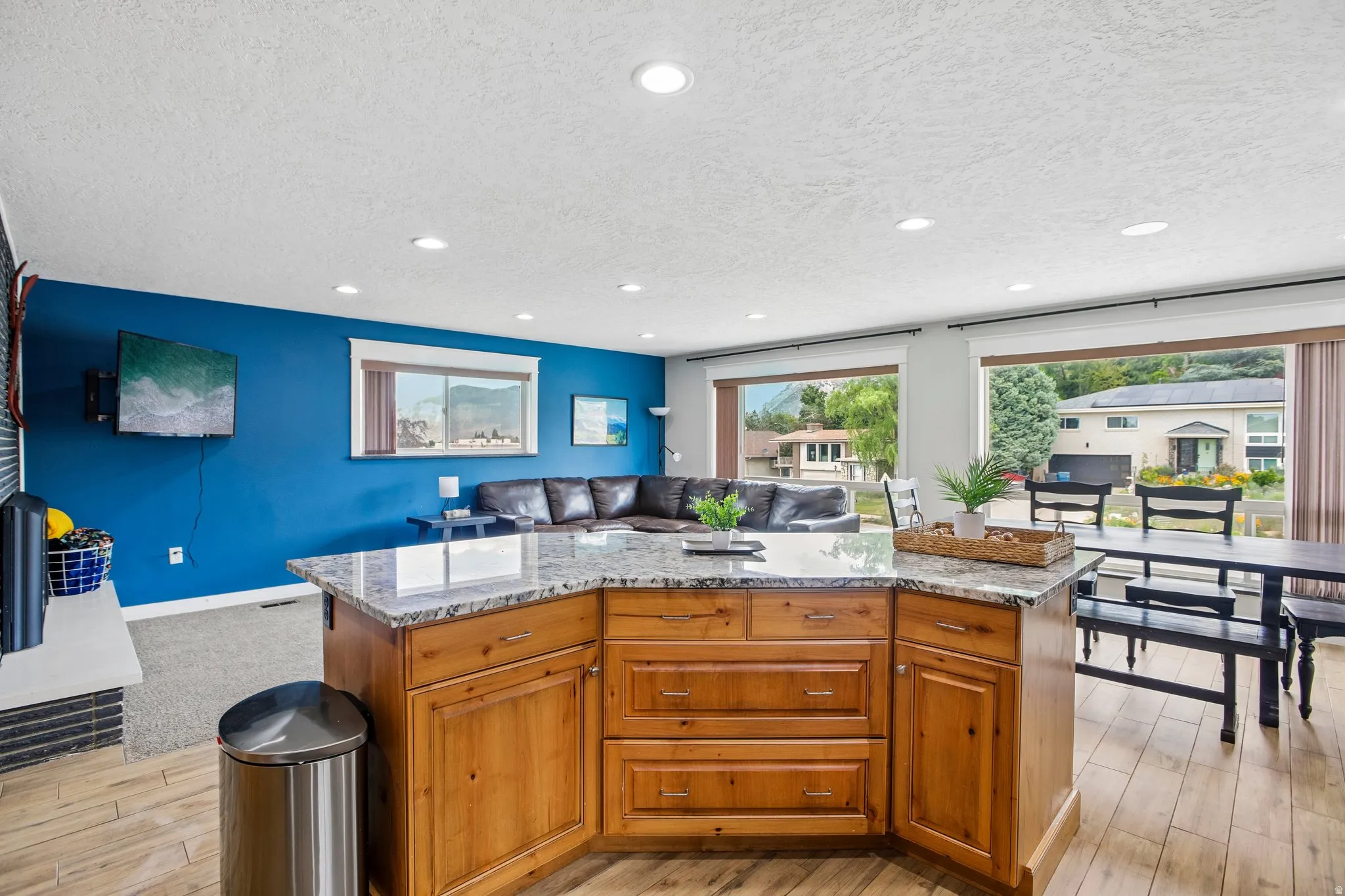 Kitchen island with a granite-style countertop and wood cabinetry
