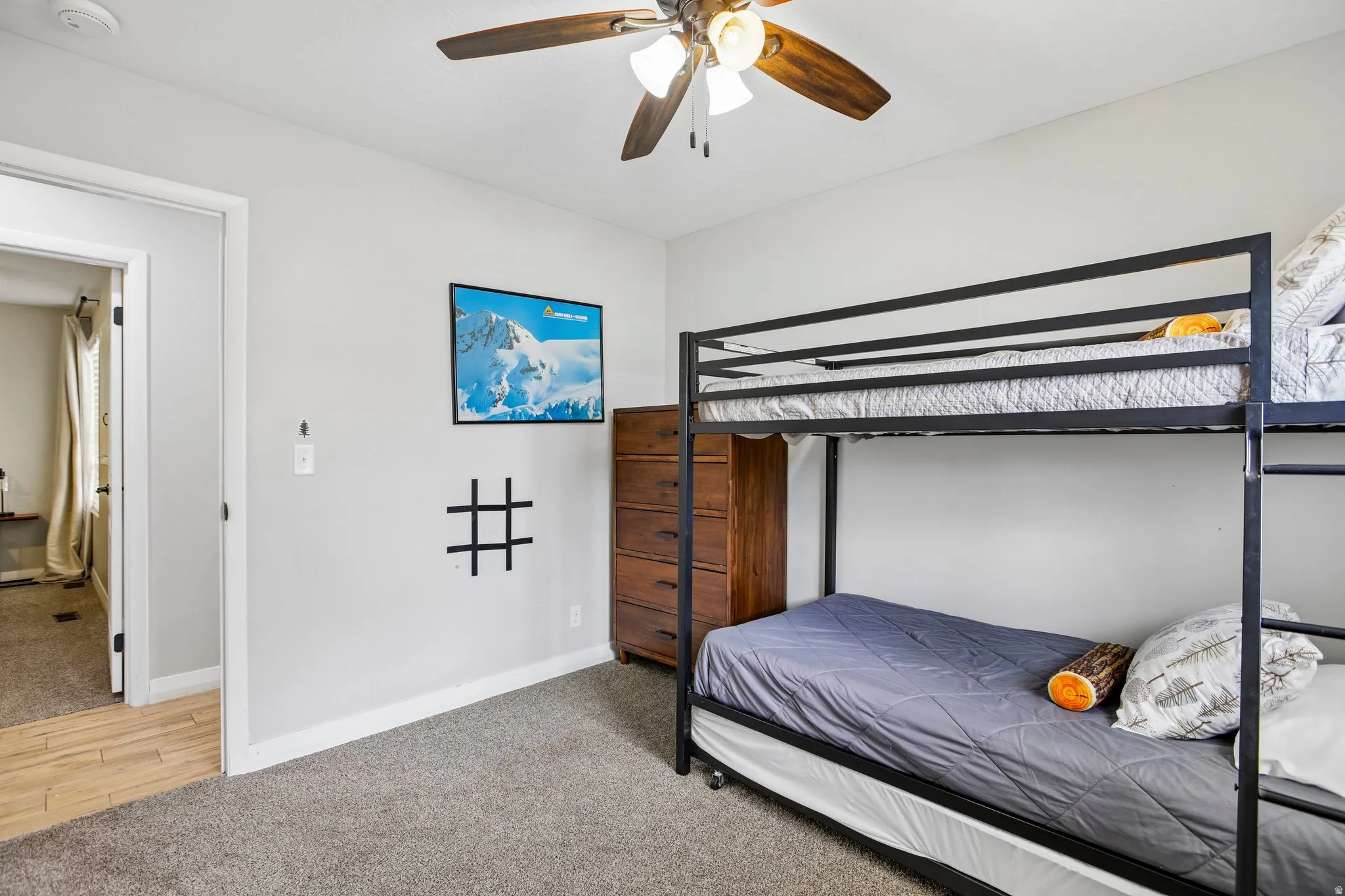 Neutral-toned walls complement the gray carpeting
