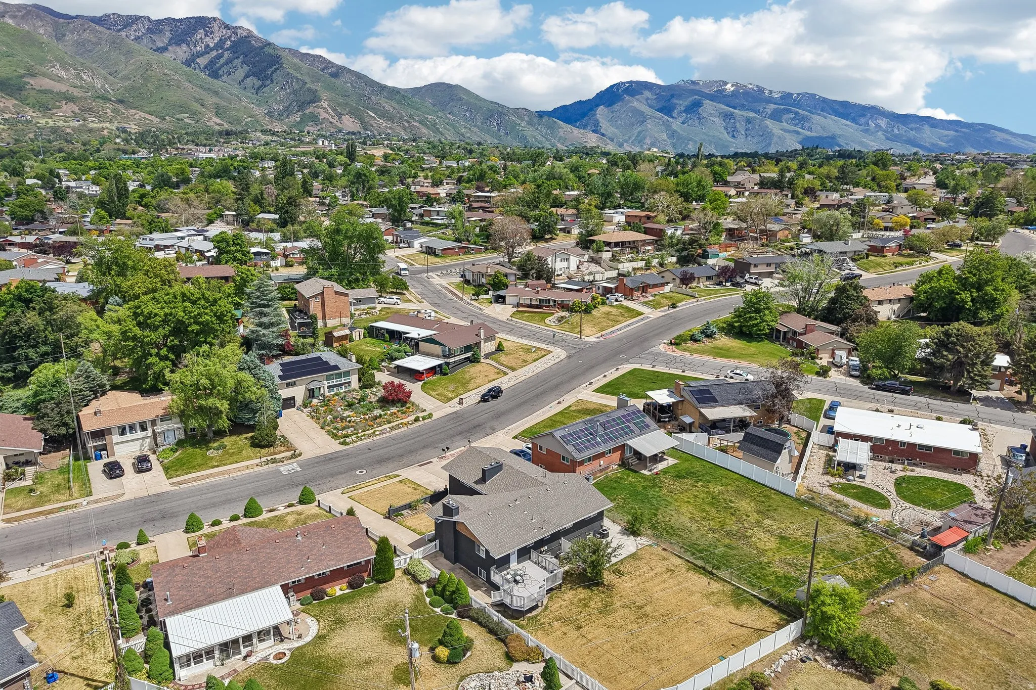 Aerial perspective showcasing a residential neighborhood with mountain scenery