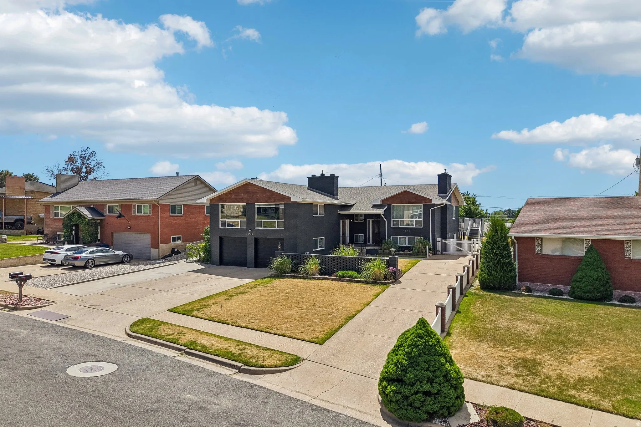 Contemporary-style residence with a dark exterior, showcasing wood-finish accent panels
