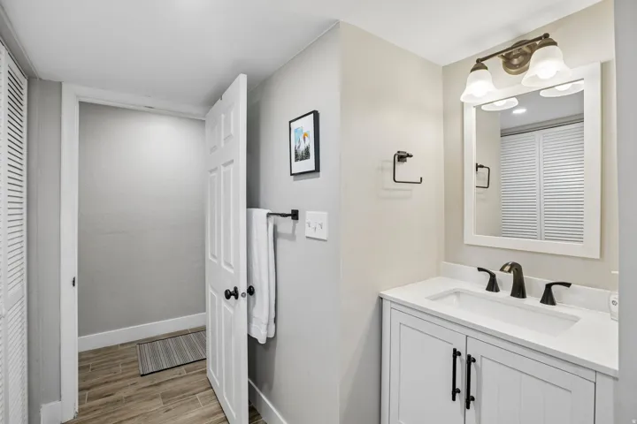 Bathroom featuring a white vanity with a rectangular sink, a white countertop, and matte black fixtures