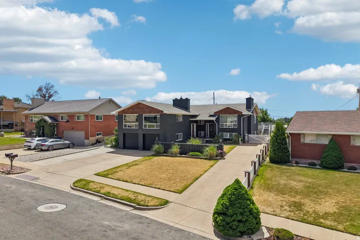 Contemporary-style residence with a dark exterior, showcasing wood-finish accent panels