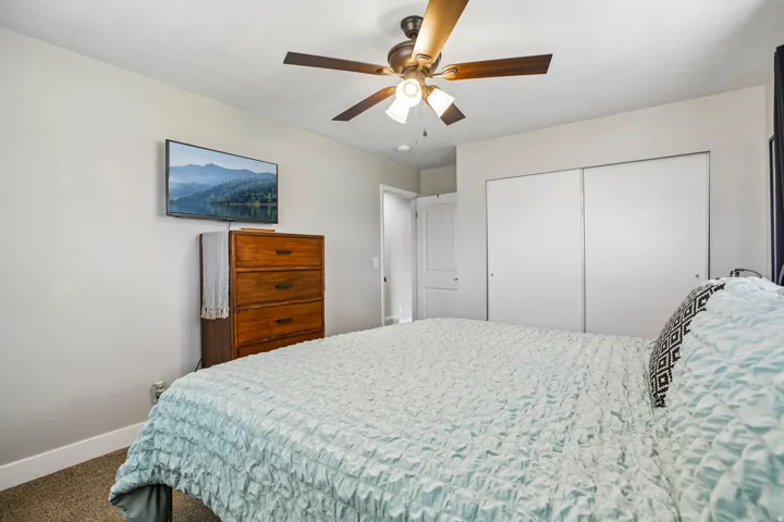 Recessed lighting with a ceiling fan fixture, carpet flooring, and white sliding closet doors
