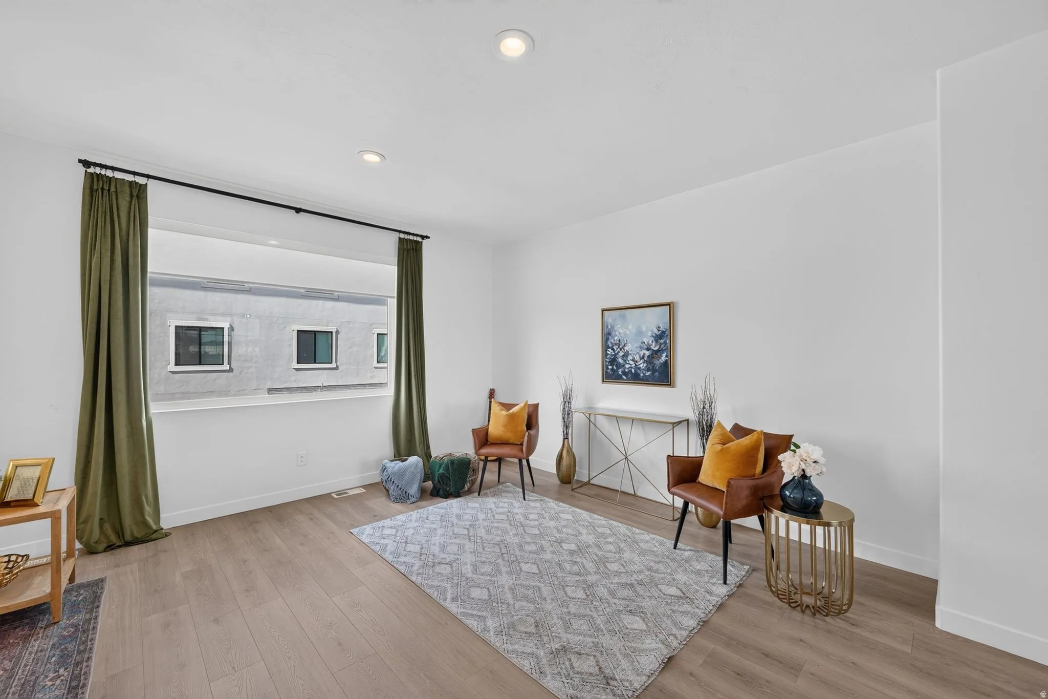 Bright interior space featuring a large window with a black rod
