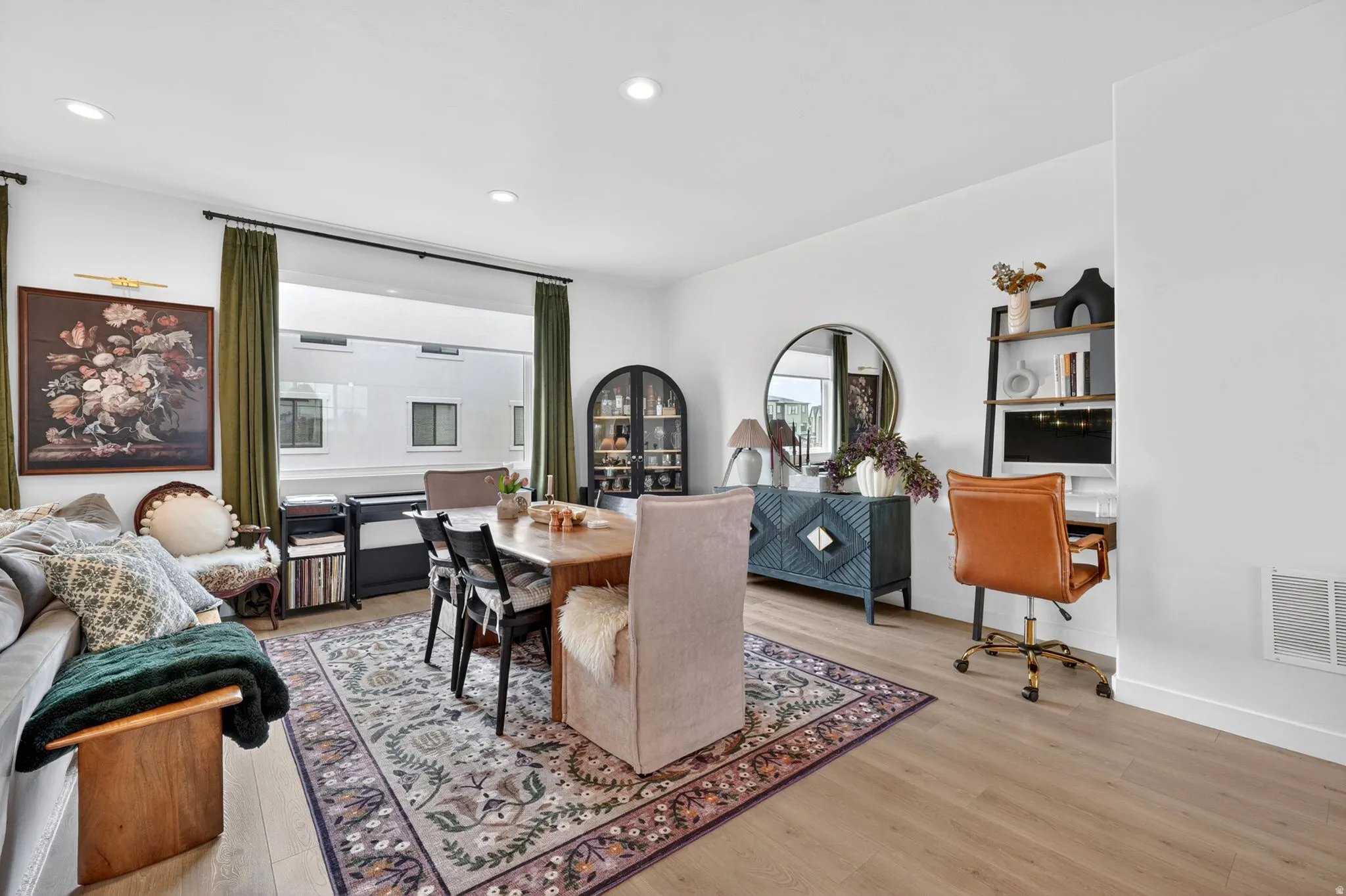 Open-concept living space with light wood-finish flooring
