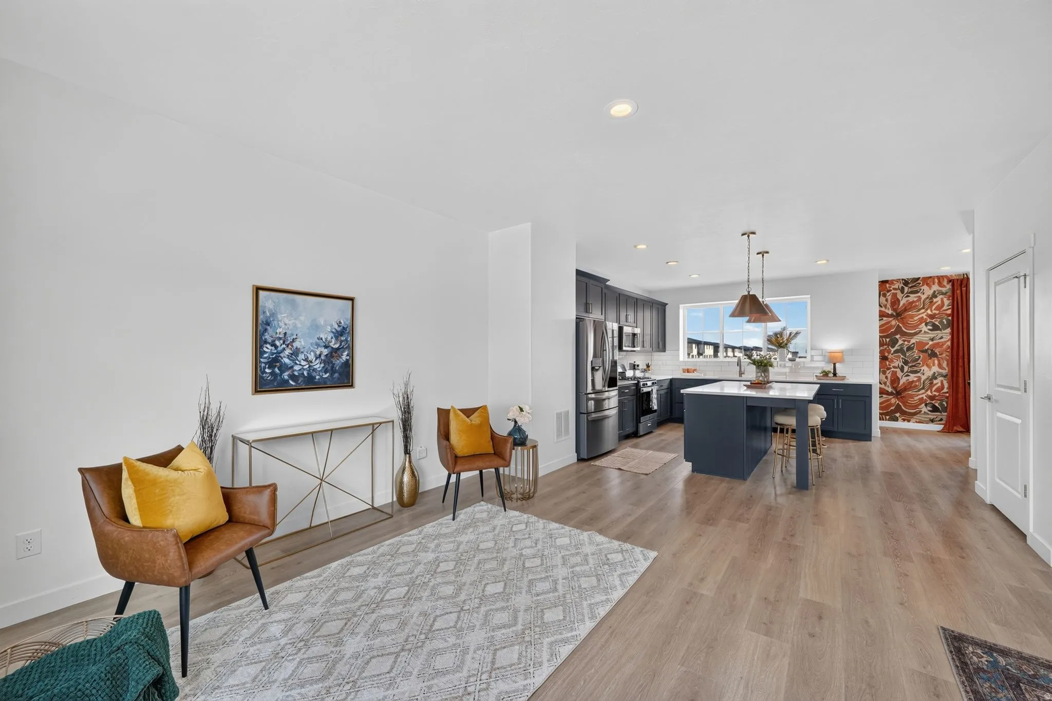 Open-concept living space featuring wood-finish flooring, recessed lighting, and white walls