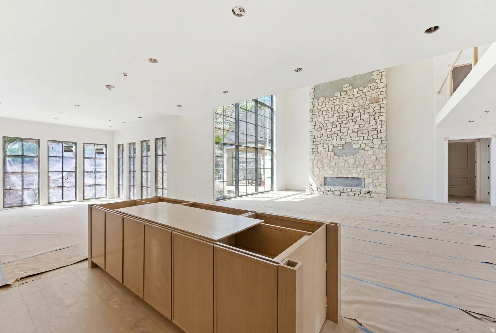 Expansive living space featuring a stone-clad fireplace with an integrated linear firebox