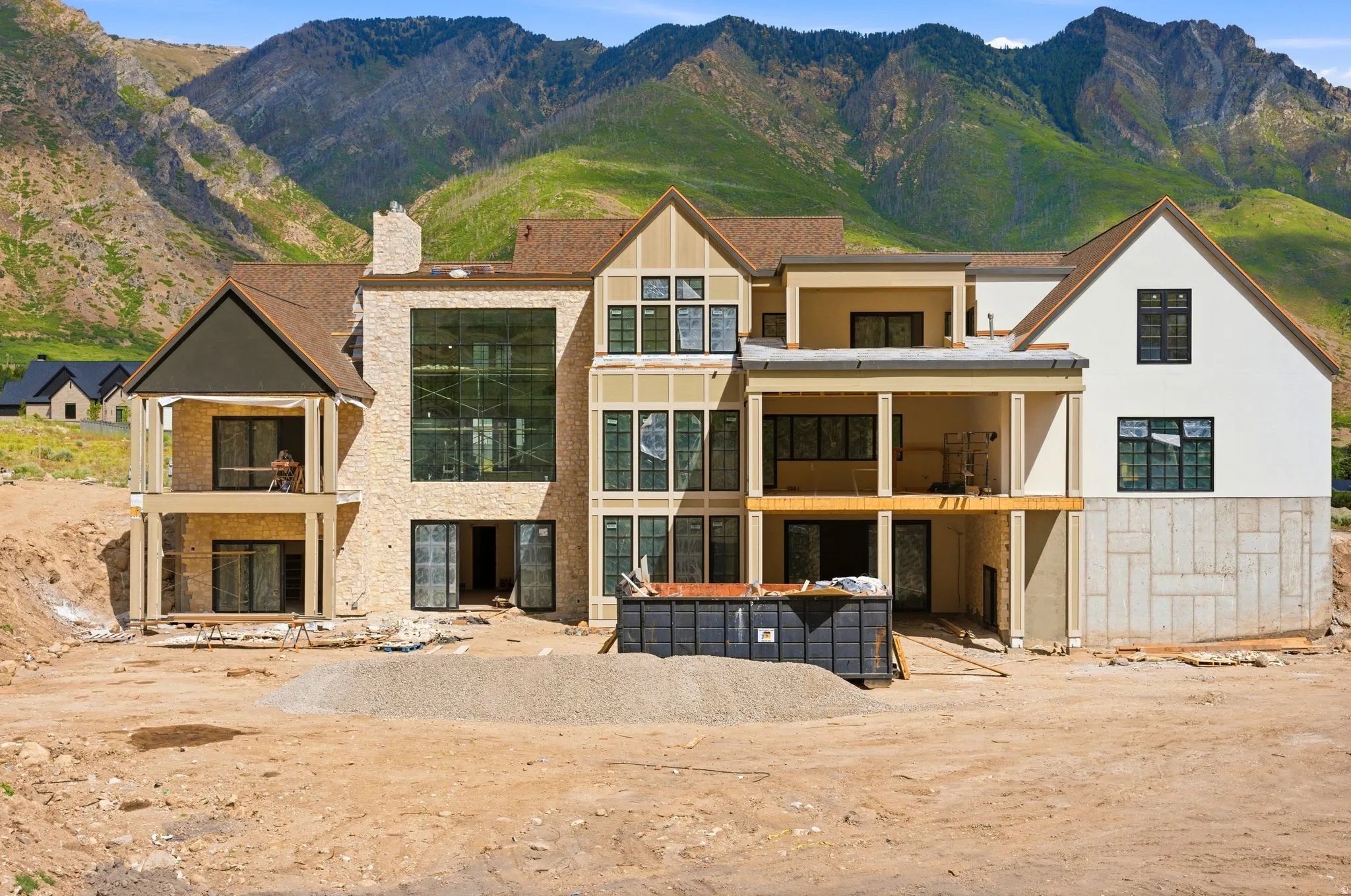 Contemporary multi-level residence featuring a stone facade and extensive window walls