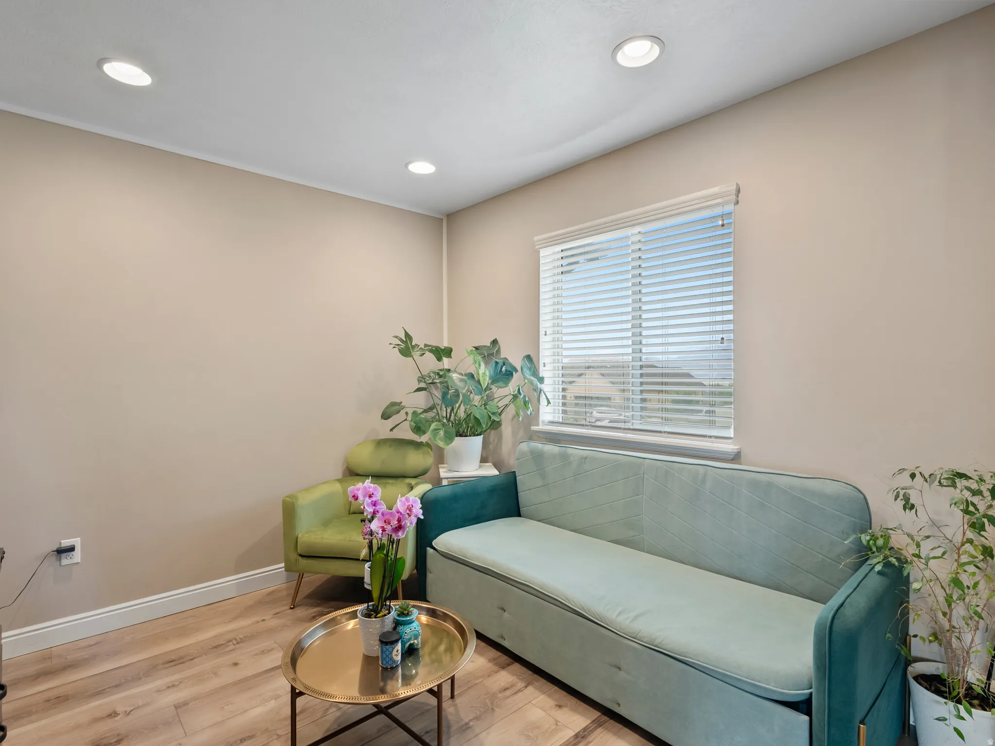 Recessed ceiling lighting, wood-finish flooring, and a single window with blinds