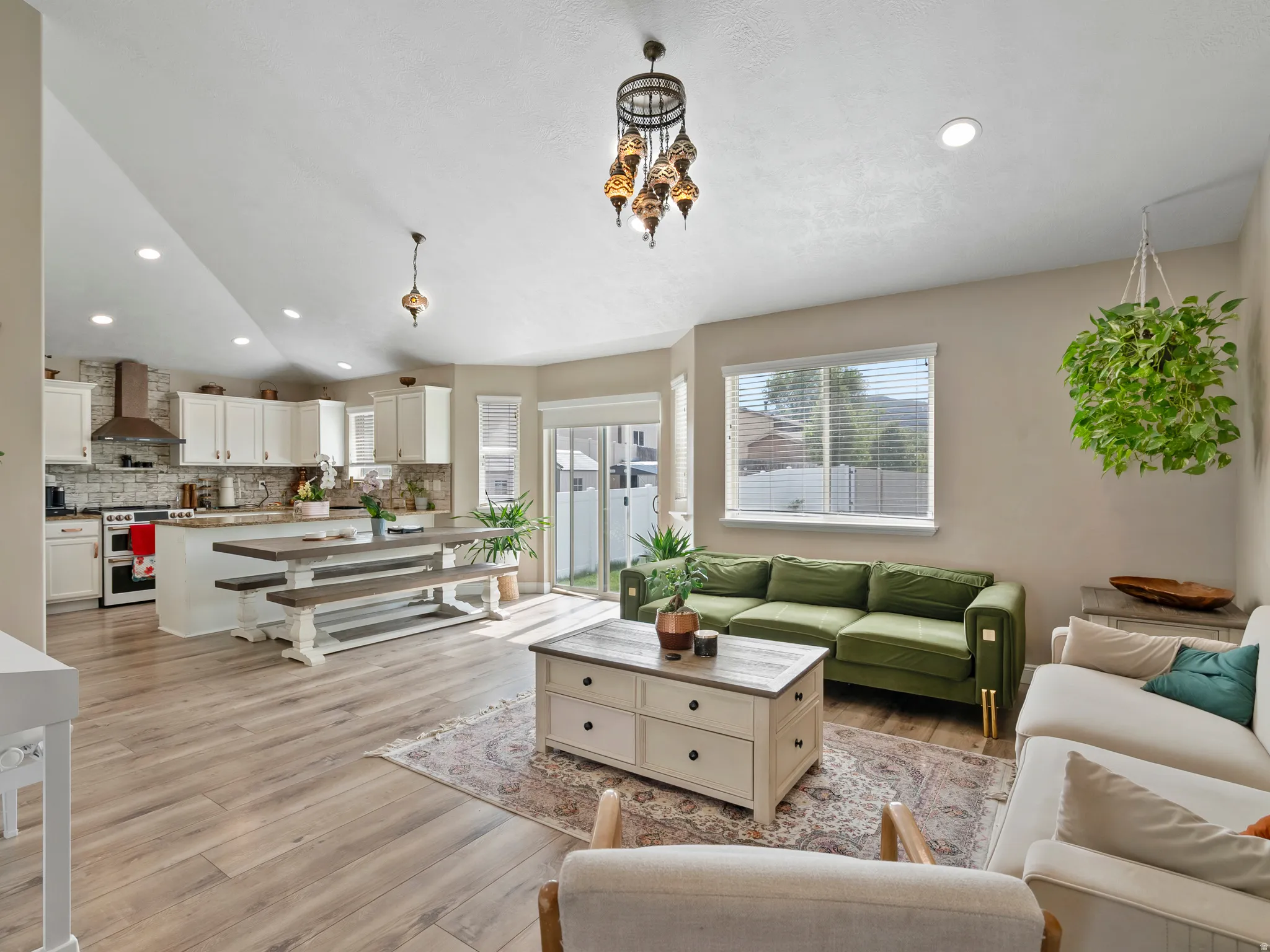 Open-concept living area featuring wood-finish flooring and recessed lighting