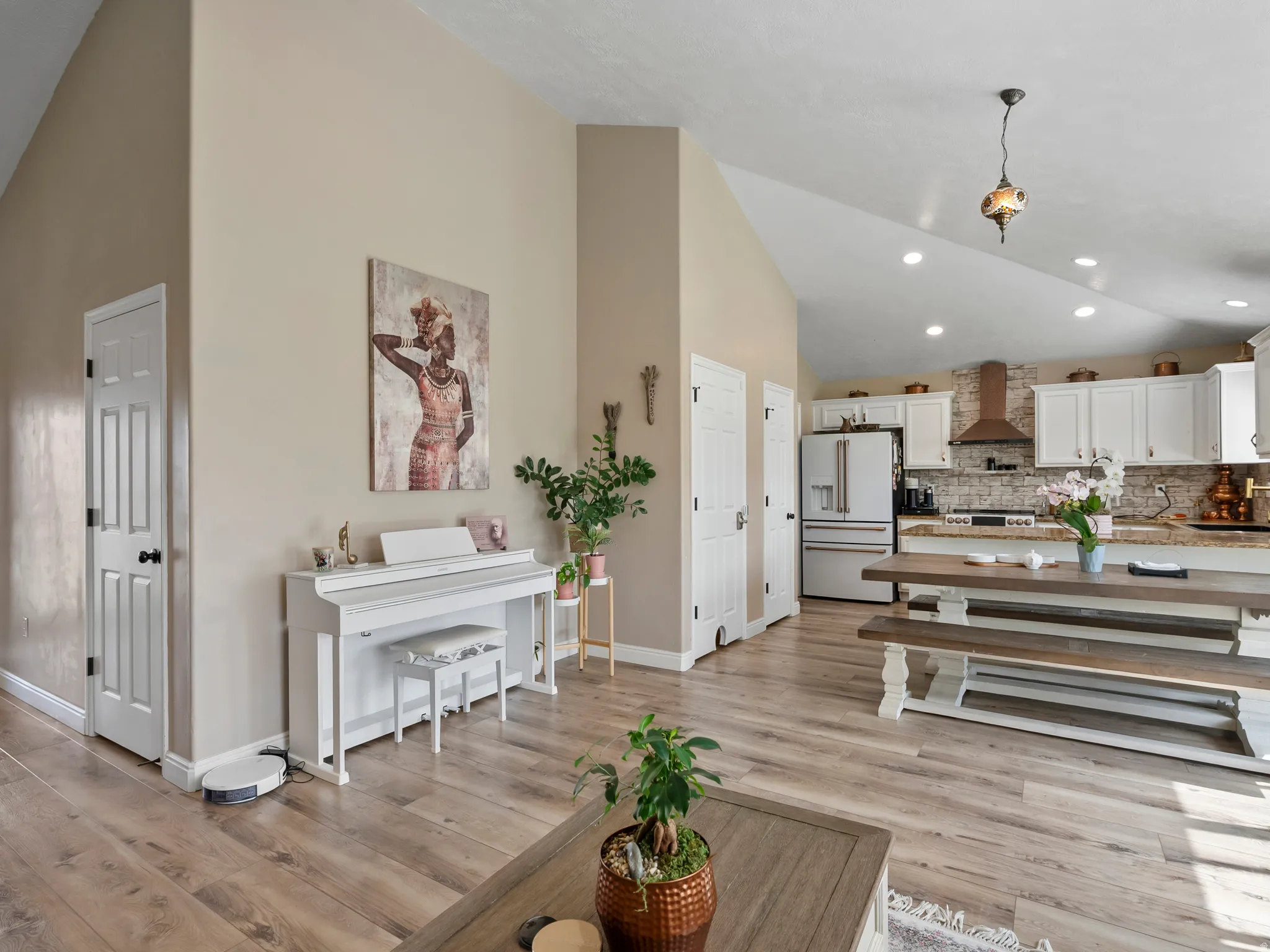 Vaulted ceilings accentuate the open-concept design featuring wood-finish flooring throughout