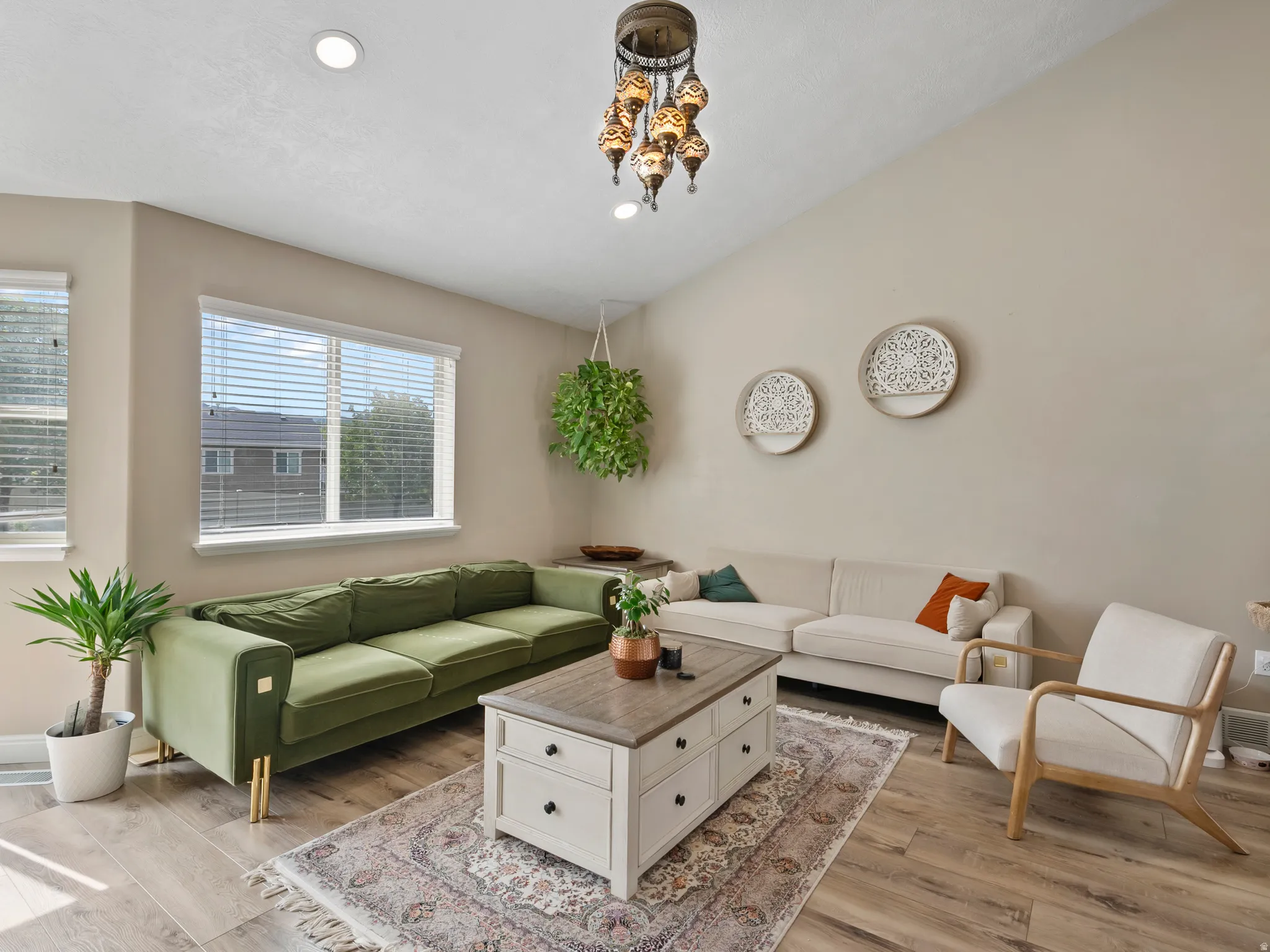 Vaulted ceiling living area featuring recessed lighting and a decorative chandelier