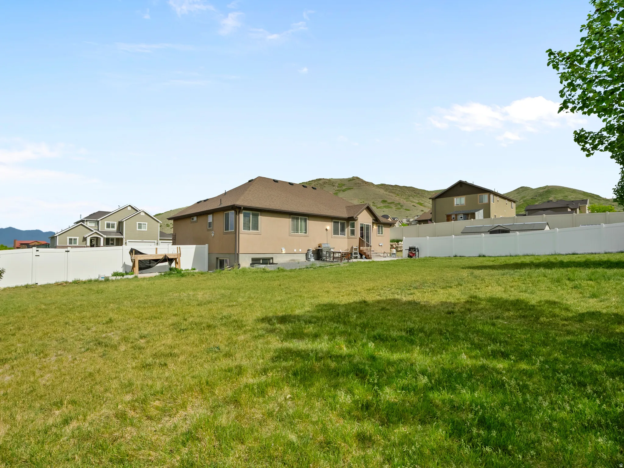 Expansive green lawn with a vinyl privacy fence