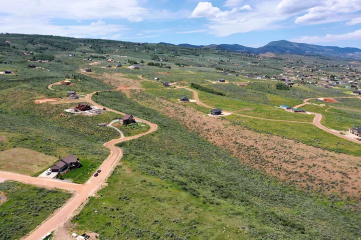 Expansive rural landscape featuring winding roads and scattered residential properties