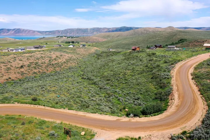 Expansive undeveloped land featuring a winding dirt road and varied topography