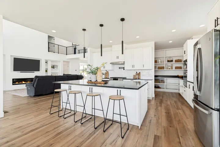 Open-concept kitchen and living area featuring wood-finish flooring