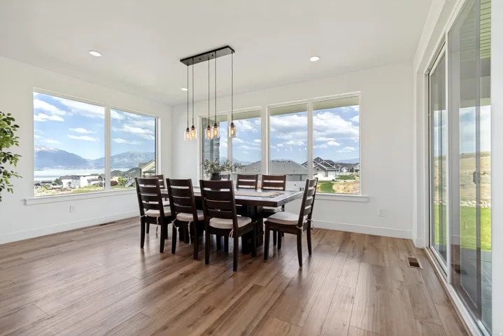 Spacious interior featuring wood-finish flooring, recessed lighting, and white baseboards