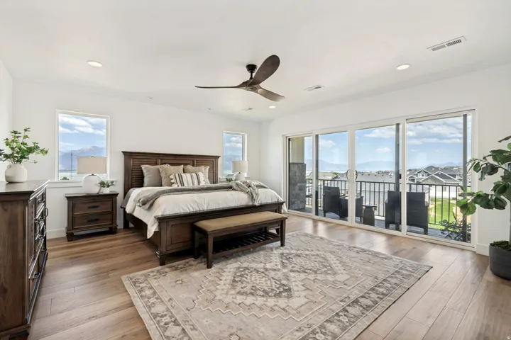 Spacious room featuring wood-finish flooring, recessed lighting, and a ceiling fan