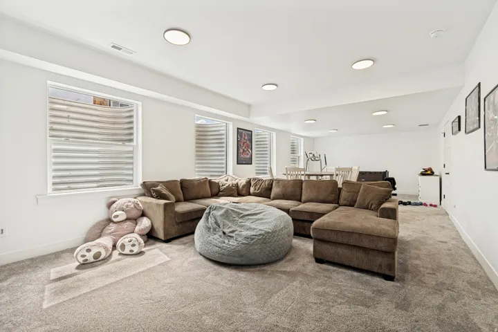Spacious lower-level room featuring light-toned carpeting and recessed ceiling lighting