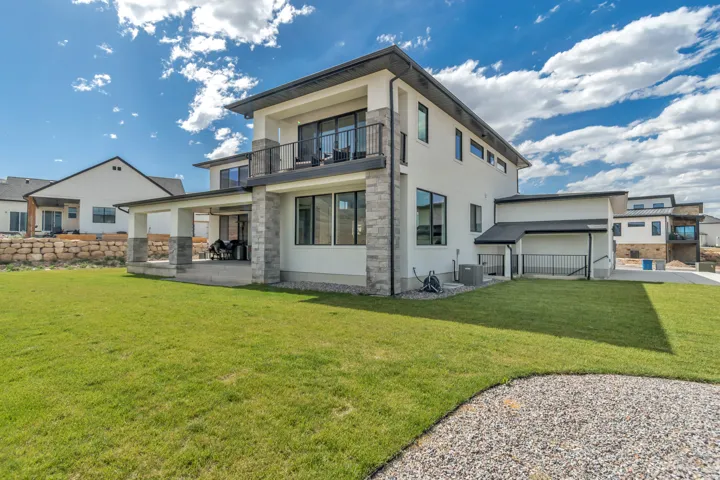 Contemporary exterior featuring white stucco and stone veneer accents