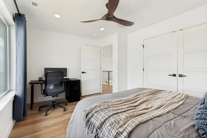 Spacious room with light wood-finish flooring and recessed lighting