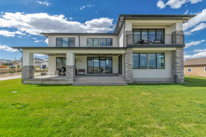 Modern two-story residence with a stucco and stone veneer exterior