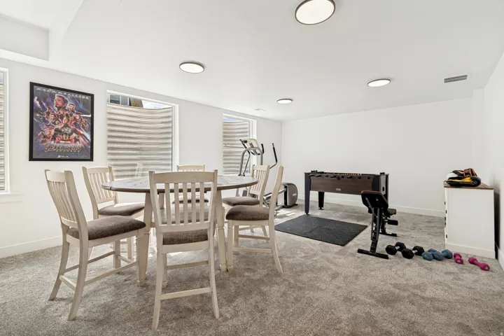 Bright multi-purpose room featuring plush carpeting and multiple windows