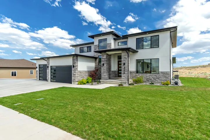 Contemporary exterior featuring white stucco and stone veneer accents