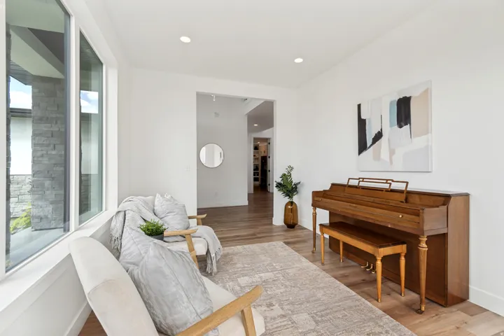 Bright interior space featuring wood-finish flooring, recessed lighting, and large picture windows