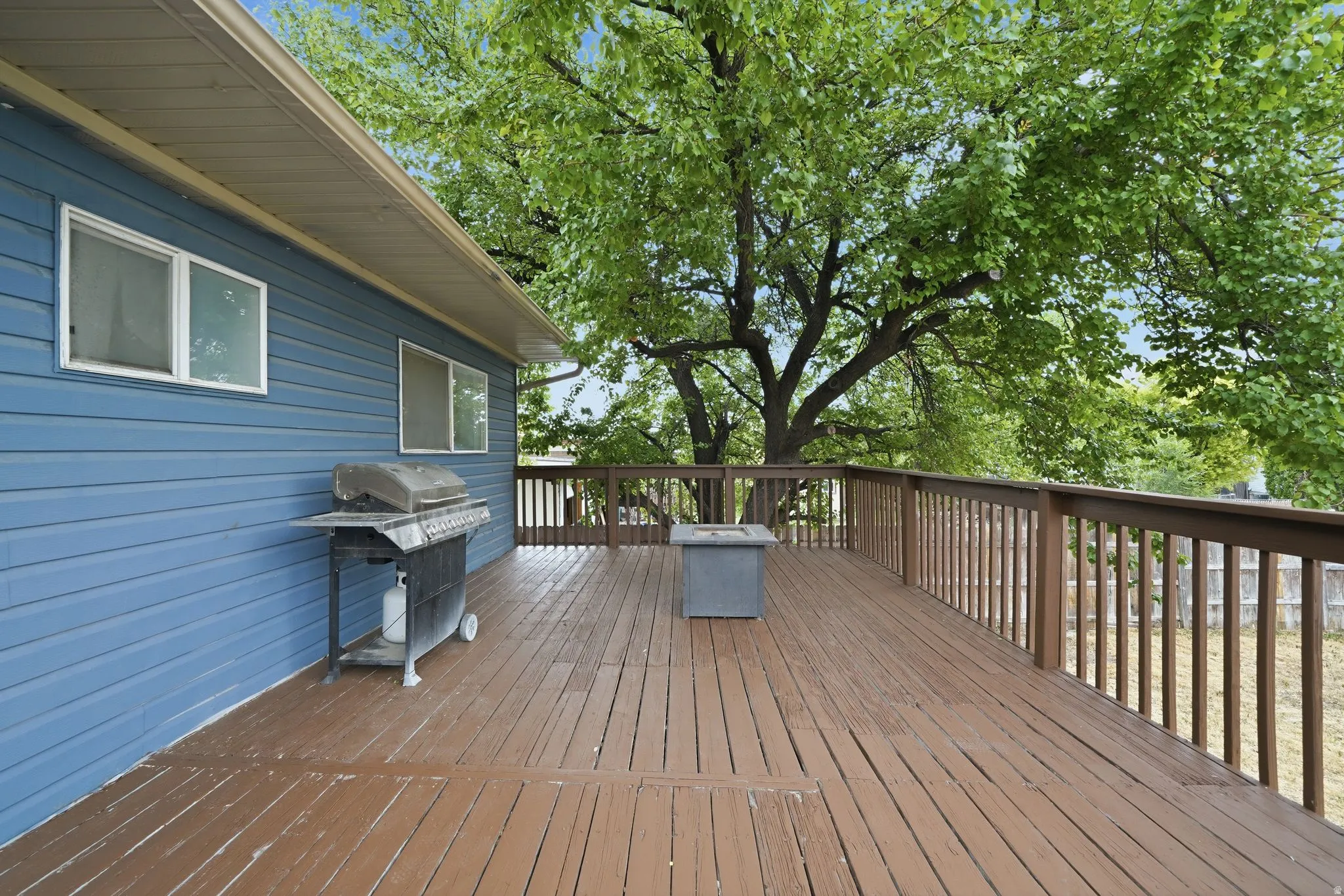 Expansive wood-finish deck with full railing system