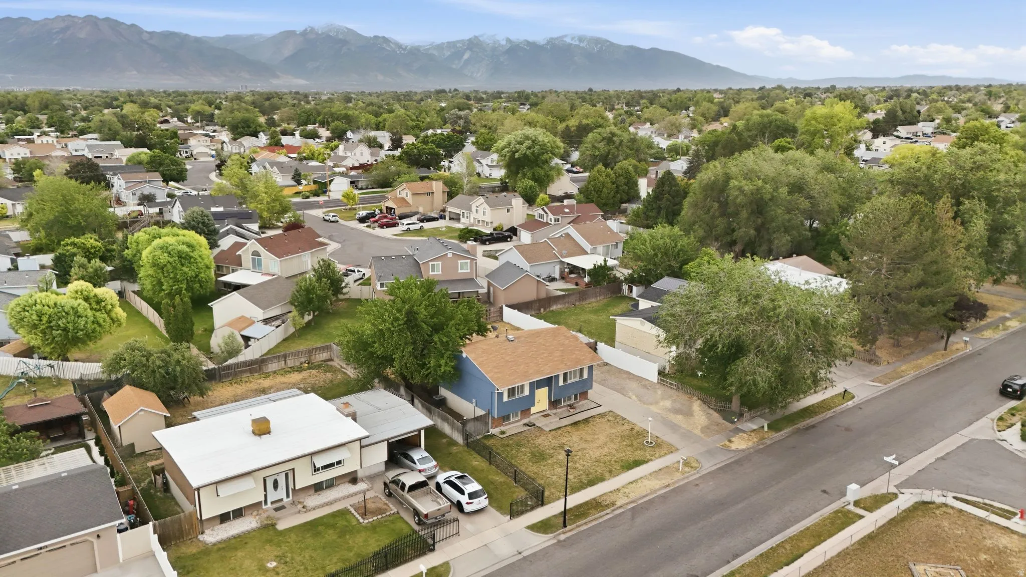 Aerial perspective showcasing a residential neighborhood with distant mountain range