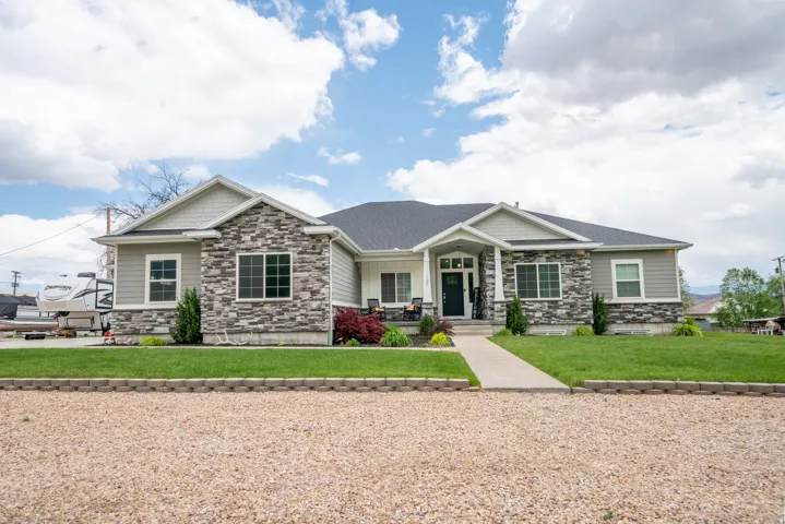 Ranch-style exterior featuring stone veneer, horizontal siding, and a dark shingle roof