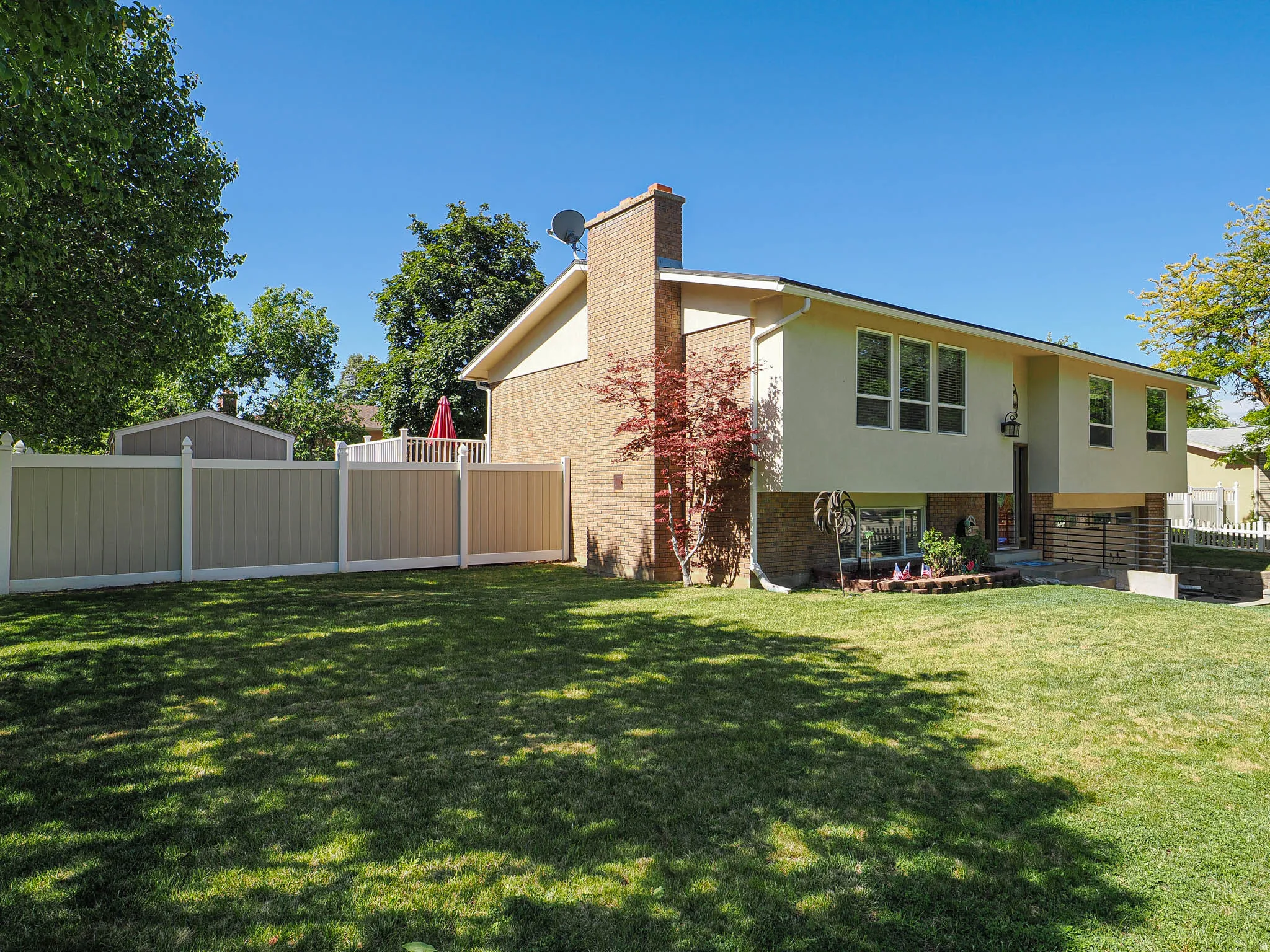 Expansive lawn with a two-tone privacy fence