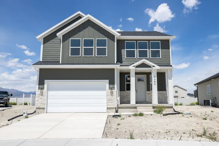 Spruce Elevation B with front yard landscaping to be installed and decorative concrete wall on rear boundary.