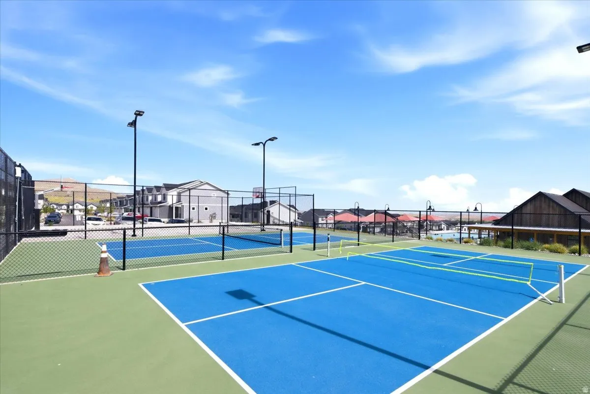 Recreational facility featuring multiple courts with blue playing surfaces and green surrounds