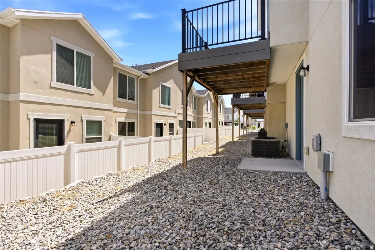 Low-maintenance exterior featuring stucco siding and a gravel ground cover