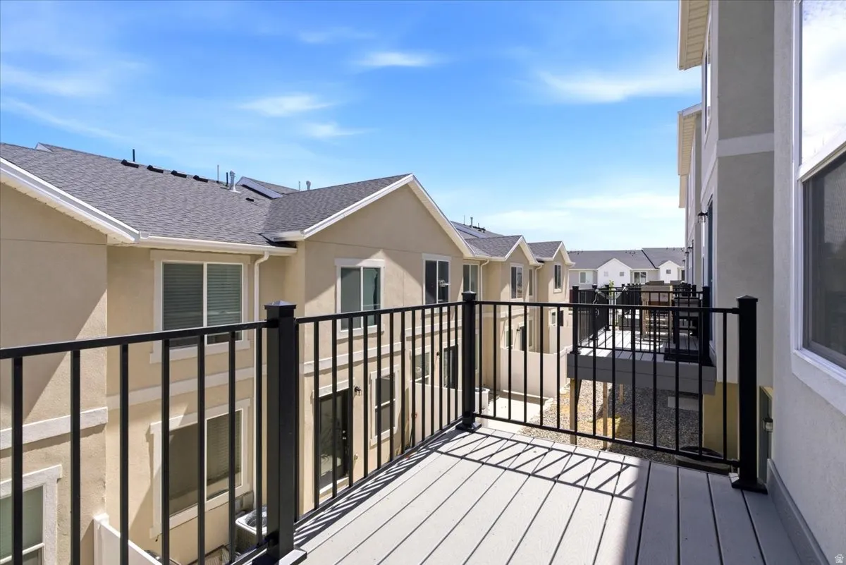 Private balcony featuring composite decking and black metal railings