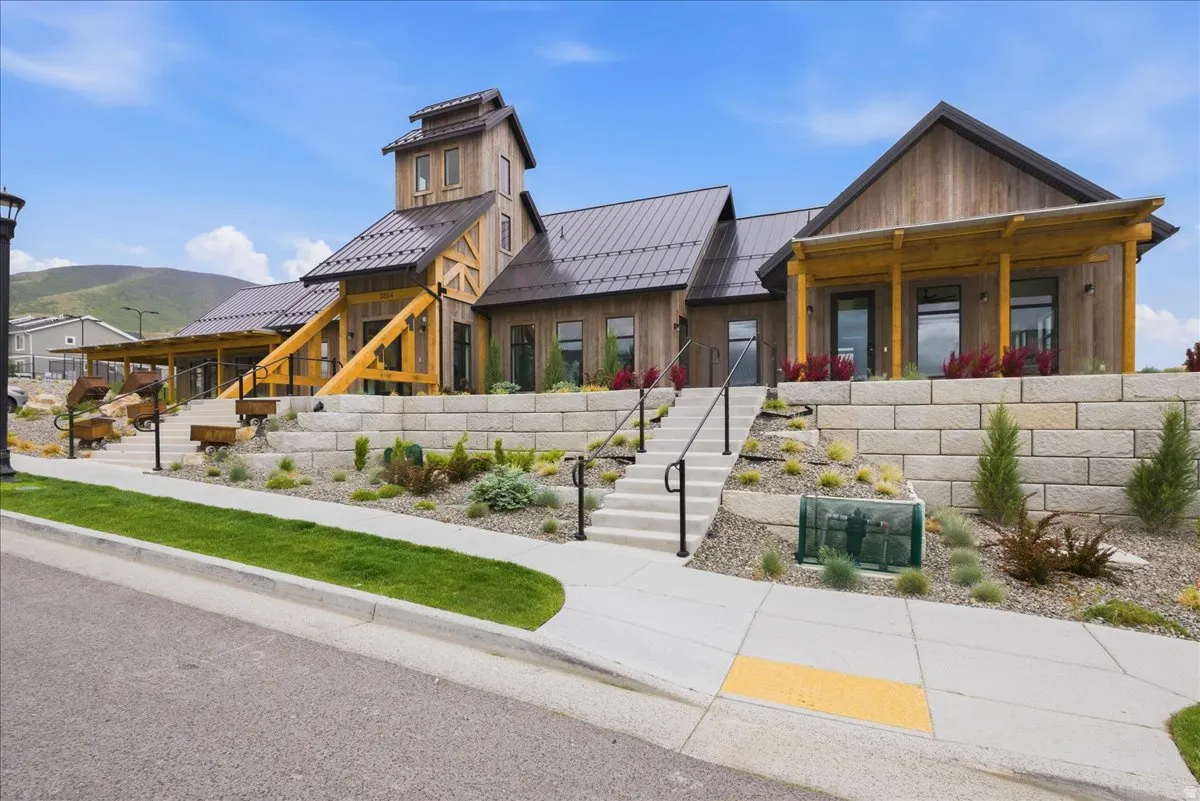 Rustic-inspired architecture featuring a prominent tower and warm wood siding