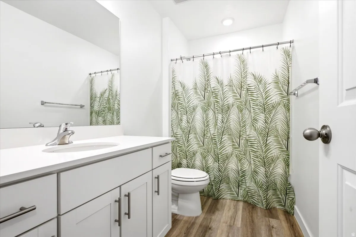 Bathroom featuring a white vanity with an integrated sink, polished chrome faucet, and a large wall-mounted mirror