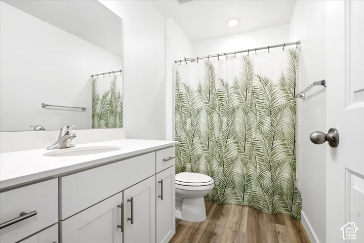 Bathroom featuring a white vanity with an integrated sink, polished chrome faucet, and a large wall-mounted mirror