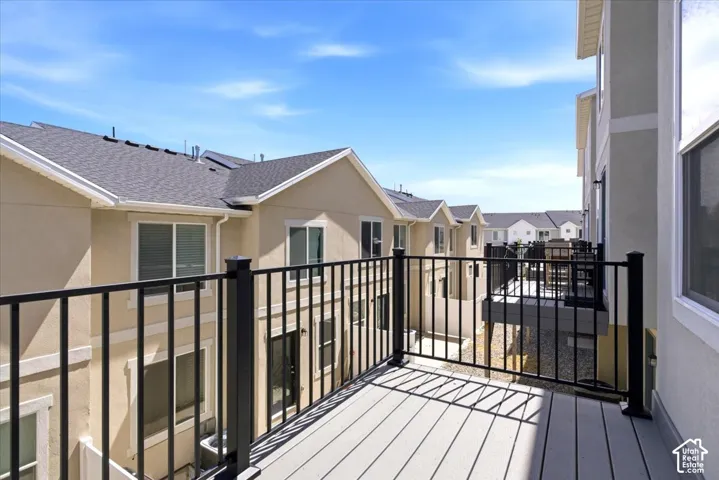 Private balcony featuring composite decking and black metal railings