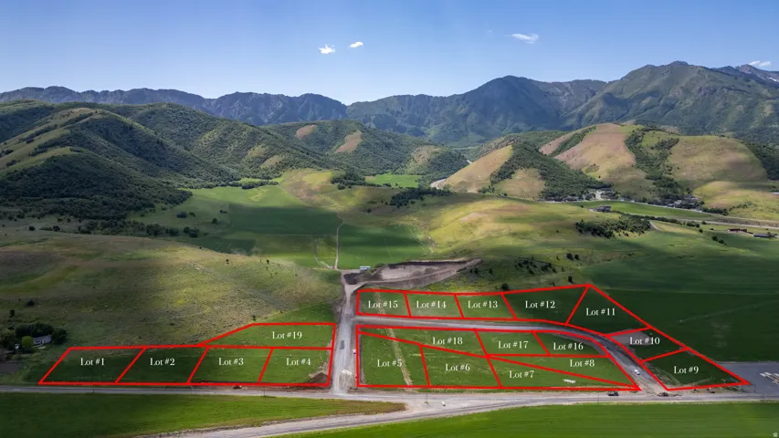 Expansive land development featuring multiple marked lots with mountain backdrops