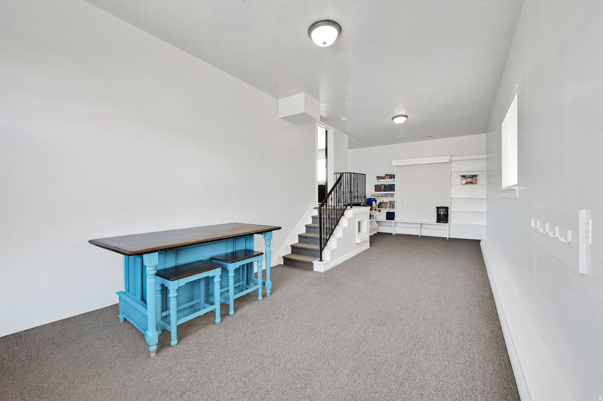 Spacious room with gray carpet flooring and white walls