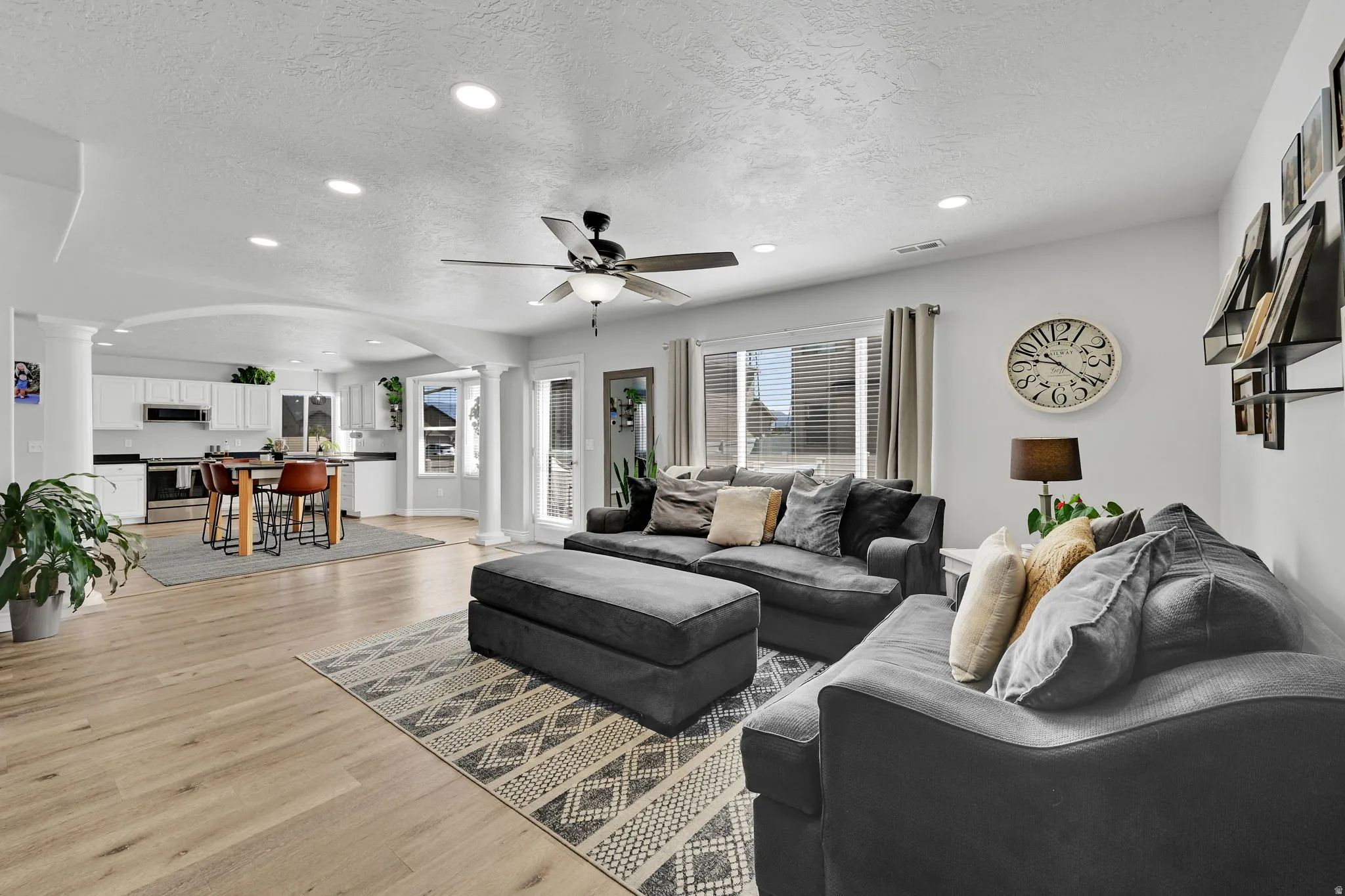 Open-concept living space featuring wood-finish flooring and recessed lighting