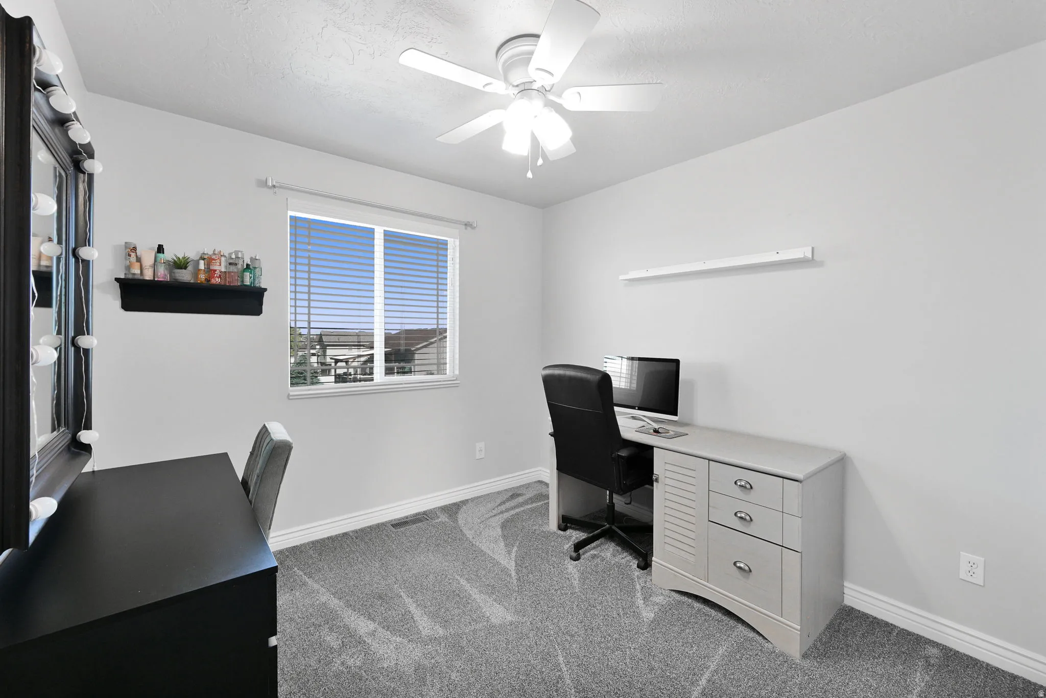 Neutral wall paint contrasting with patterned carpet flooring
