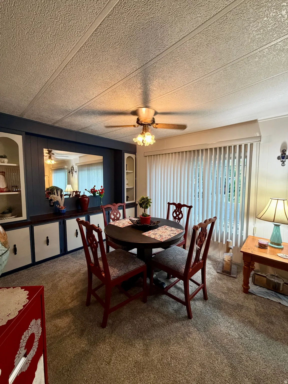 Dining area featuring built-in cabinetry with open shelving and closed storage
